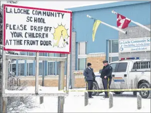  ?? CP PHOTO ?? Members of the RCMP stand outside the La Loche Community School in La Loche, Sask., on Jan. 25, 2016. Sentencing was delayed on Friday at the hearing for a teenager who shot and killed four people and injured seven others at a home and a high school in...