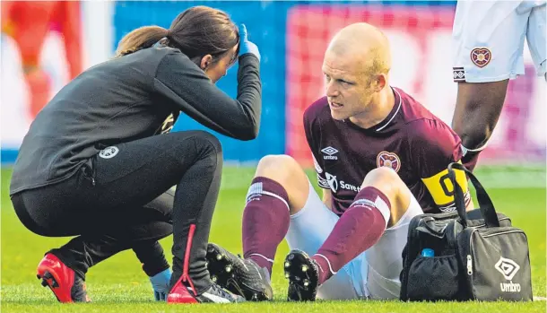  ??  ?? PAIN GAME: Agony for Steven Naismith as he is forced to leave the pitch early in the Betfred Cup semi-final against Celtic at Murrayfiel­d on Sunday