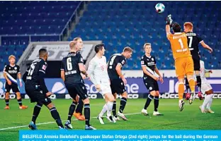  ?? —AFP ?? BIELEFELD: Arminia Bielefeld’s goalkeeper Stefan Ortega (2nd right) jumps for the ball during the German first division Bundesliga football match between DSC Arminia Bielefeld and FC Bayern Munich on October 17, 2020.