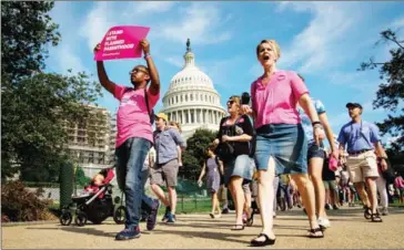  ?? DREW ANGERER/GETTY IMAGES NORTH AMERICA/AFP ?? Activists march around the US Capitol to protest the Senate GOP health care bill, on Capitol Hill, on June 28, in Washington, DC.