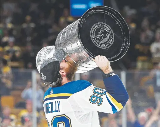  ?? Patrick Smith, Getty Images ?? St. Louis’ Ryan O'Reilly hoists the Stanley Cup on Wednesday night after the Blues defeated the Boston Bruins 4-1 to win Game 7 of the Final in Boston. O’Reilly, who played for the Avalanche from 2009-15, also won the Conn Smythe Trophy as MVP of the postseason.