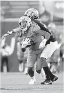  ?? PATRICK LANTRIP/AP ?? Memphis wide receiver Calivin Austin III comes up with a catch against UCF during Saturday’s game in Memphis, Tenn.