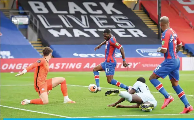  ?? — AFP ?? LONDON: Crystal Palace’s Zaire-born Belgian striker Christian Benteke (C) scores their second goal during the English Premier League football match between Crystal Palace and Chelsea at Selhurst Park in south London.