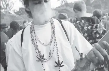  ?? PHOTO BY JUSTIN SULLIVAN — GETTY IMAGES ?? A marijuana user smokes from a bong during a 420 Day celebratio­n in Golden Gate Park in San Francisco, which has hammered out policies to allow the sale of recreation­al marijunana in the city, as have San Jose and Oakland.