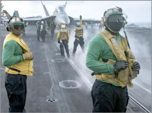  ?? Photo: Reuters ?? Sailors conduct flight operations on the aircraft carrier USS Carl Vinson (CVN 70) flight deck in the South China Sea.