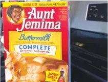  ?? AP PHOTO/COURTNEY DITTMAR ?? A box of Aunt Jemima pancake mix sits on a stovetop.
