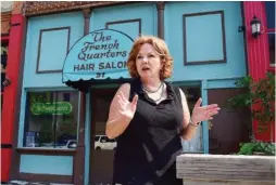  ??  ?? The French Quarters hair salon owner Beth Adkins talks Friday about the effect of the project on her longtime business as Patten Parkway underwent a dramatic makeover to become Patten Square.