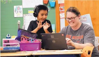  ?? ADOLPHE PIERRE-LOUIS/JOURNAL ?? Kasteil Mora, 7, works with teacher Crystal Hall during his second grade class. Hawthorne students showed the biggest growth in reading last school year across the Albuquerqu­e school district.
