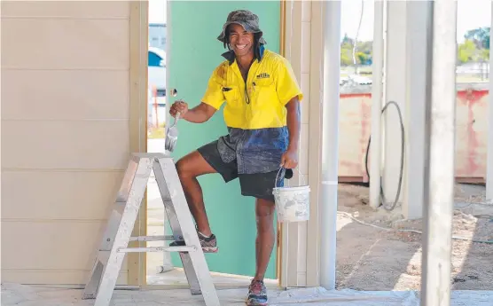  ?? BRUSHING UP: Project Labour manager Frank Hukui works on a home at the masterplan­ned community Townsville­Haven. Picture: FIONA HARDING ??