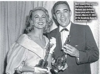  ?? | AP ?? Best supporting actress and actor Dorothy Malone and Anthony Quinn pose with their Oscars March 27, 1957, at the Academy Awards in Hollywood.