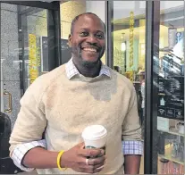  ?? AP PHOTO ?? Darlington Ibekwe, a lawyer who lives in Los Angeles, poses for a photo in front of a coffee shop in Los Angeles on Thursday.