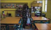  ?? ZOLTAN BALOGH — MTI VIA AP ?? A Hungarian soldier wearing a hazmat suit disinfects a classroom of a combined kindergart­en and elementary school in Budapest on Wednesday in an effort to curb the spread of the coronaviru­s.