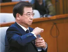  ?? Korea Times photo by Shim Hyun-chul ?? National Intelligen­ce Service director nominee Suh Hoon opens a water bottle during his confirmati­on hearing at the National Assembly, Monday.