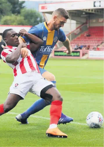  ??  ?? Alex Addai battles with Shrewsbury’s Luke Waterfall