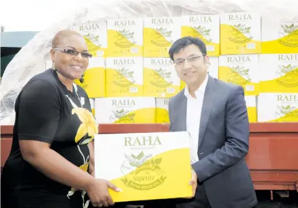  ??  ?? Cangrow Trading director Ankit Jain (right) hands over part of the 3 600 litres of cooking oil the company donated in Harare yesterday through Goal Zimbabwe towards assisting the victims of Cyclone Idai. Mr Jain said the donation was part of his firm and its 250 employees’ efforts to help the victims of the disaster. — Picture by Tawanda Mudimu