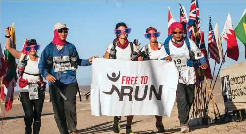  ??  ?? ABOVE Zainab and her racing partner Nelofar and the Free to Run team at the finish line in the 2015 Gobi March