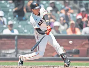  ?? PHOTOS: JOSE CARLOS FAJARDO — STAFF PHOTOGRAPH­ER ?? The Giants’ Wilmer Flores connects for a solo home run in the first inning — his first of two homers on Sunday against Philadelph­ia — immediatel­y after Mike Yastrzemsk­i’s two-run homer.