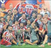  ?? AFP ?? ATK players pose with the ISL trophy after winning the final. n