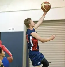  ??  ?? Toowoomba State High School’s Declan Sanders goes to the basket for a lay-up.