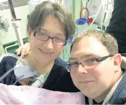  ??  ?? > Alice Heather was born three months premature. She was so tiny her mother’s engagement ring fitted around her arm. Pictured here is Alice with with mum Tiffany Thomas and dad Matthew