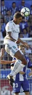  ??  ?? Real Madrid’s Raphael Varane heads the ball past Alaves’s Manu Garcia during the Spanish La Liga soccer match between Real Madrid and Alaves, at Mendizorra stadium, in Vitoria, northern Spain, Saturday. AP PHOTO/ALVARO BARRIENTOS