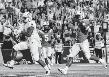  ?? Michael Shroyer / Getty Images ?? With a 40-yard touchdown run in the final two minutes, Jeremy Cox seals Old Dominion’s stunning upset of 13th-ranked Virginia Tech on Saturday. Cox ran for 130 yards in the game between cross-state schools.