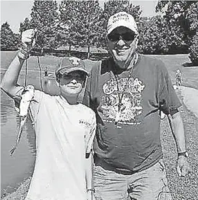  ?? SUBMITTED ?? Ron McSwain of Germantown helps his grandson share in a memory-making moment at 2017 Mid-South Junior Fishing Rodeo