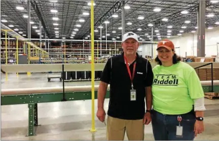  ?? CAROL HARPER — THE MORNING JOURNAL ?? Production Manager Mark Daley and Human Resources Director Leigh Cullen said they were excited to show the community a new almost 350,000-square-foot facility to manufactur­e and reconditio­n football helmets and equipment at 7501 Performanc­e Lane in...