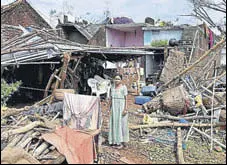  ?? PTI ?? A woman stands near the debris of her house that was damaged by Cyclone Titli in Andhra Pradesh’s Srikakulam on Friday.