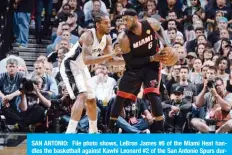  ??  ?? SAN ANTONIO: File photo shows, LeBron James #6 of the Miami Heat handles the basketball against Kawhi Leonard #2 of the San Antonio Spurs during Game Five of the 2014 NBA Finals between the Miami Heat and San Antonio Spurs at AT&T Center on June 15, 2014 in San Antonio, Texas. —AFP