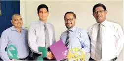  ??  ?? Shiraz Lye, Director Sales & Marketing South Asia - IFS handing over the agreement to Pawan Tejwani, Managing Director of Cable Solutions Lanka, as Mithila Ranjithan- Principal Consultant IFS South Asia and Priyanka Irugalband­ara, Director Quality...