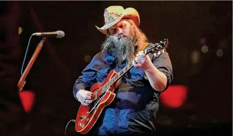  ?? Karen Warren/Staff photograph­er ?? Chris Stapleton performs Thursday at RodeoHoust­on. His set got off to a sleepy start with songs like “Parachute” and “Starting Over,” but he picked up the pace with “Worry B Gone.” “Fire Away” shifted the energy in the crowd of over 73,000.
