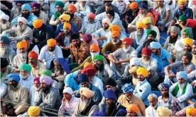  ??  ?? Protesting farmers listen to a speaker at the Delhi-Haryana state border in Singhu. Photograph: Prakash Singh/AFP/Getty Images