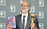  ?? AP ?? Karunatila­ka with his Booker Prize and the award-winning book.