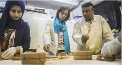  ??  ?? Quiles (centre) and local staff at the dating laboratory in IFAO in Cairo working to give a more precise chronology of Egypt’s ancient dynasties.