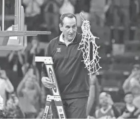  ?? KELLEY L. COX/USA TODAY SPORTS ?? Duke coach Mike Krzyzewski holds the net as the Blue Devils celebrate their win over Arkansas on Saturday.