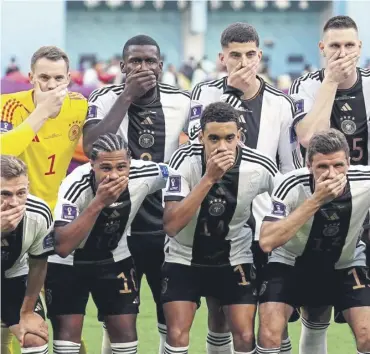  ?? ?? ↑ German players cover their mouths ahead of their first group game