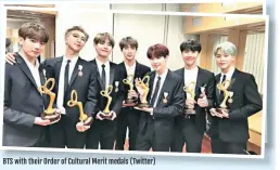  ??  ?? BTS with their Order of Cultural Merit medals (Twitter)