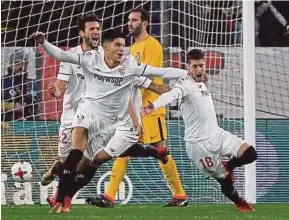  ?? REUTERS PIC ?? Sevilla’s Sergio Escudero (right) celebrates his goal against Atletico Madrid in a King’s Cup quarter-final second-leg match on Tuesday.