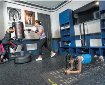  ?? Brett Coomer / Houston Chronicle ?? Neda Malkani works out with her son, Armaan, 11, and daughter, Meher, 9, in their dining/exercise room.