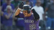  ?? DAVID ZALUBOWSKI - THE ASSOCIATED PRESS ?? FILE In this Aug. 14, 2019, file photo, Colorado Rockies’ Nolan Arenado celebrates as he circles the bases after hitting a walkoff, two-run home run off Arizona Diamondbac­ks relief pitcher Archie Bradley in the ninth inning of a baseball game in Denver. Arenado is at odds with the team’s front office as the Rockies head to spring training for the season ahead.