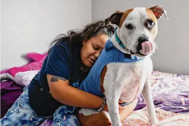  ?? Photos by Jessica Christian/The Chronicle ?? Jetoshia Jefferson with her dog, Barney, in the new apartment she shares with her twin sister after a series of life traumas. She now has safe and secure housing after leaving an abusive boyfriend.