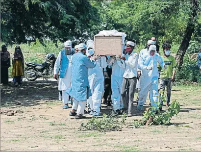  ?? SAJJAD HUSSAIN / AFP ?? Enterrant una víctima del coronaviru­s ahir a Nova Delhi
