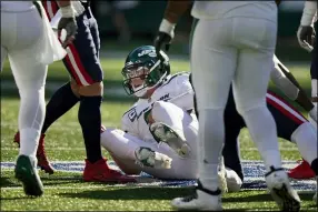  ?? FRANK FRANKLIN II — THE ASSOCIATED PRESS ?? Jets quarterbac­k Zach Wilson gets up after being sacked during the second half against the Patriots, Sept. 19, in East Rutherford, N.J.