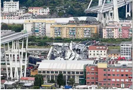  ?? — AP ?? Immense tragedy: Cars blocked on the Morandi highway bridge after a section of it collapsed in Genoa.