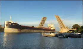  ?? RICHARD PAYERCHIN — THE MORNING JOURNAL ?? The Charles Berry Bascule Bridge rose to allow the freighter Algoma Transport to pass under when the vessel arrived in Lorain about 7:17 a.m. Oct. 5. The 730-foot vessel, operating out of Toronto, is a Great Lakes self unloading bulk carrier. On Oct. 10, Lorain Port Authority board members discussed the economic effects of shipping in Lorain.