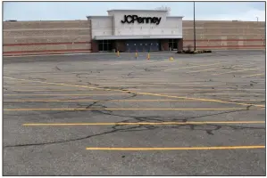  ?? (AP) ?? An empty parking lot is shown in May outside a closed J.C. Penney store in Roseville, Mich.