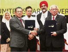  ??  ?? Prof Kamal (right) shaking hands with TNB Engineerin­g
Corporatio­n general manager Abdul Hakim Hamad (second
from left) at the event.