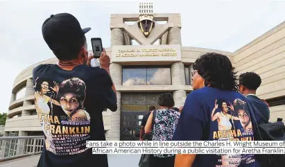  ?? Photos by AFP and AP ?? Fans take a photo while in line outside the Charles H. Wright Museum of African American History during a public visitation for Aretha Franklin.