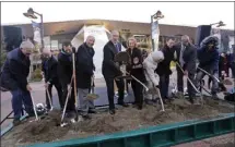  ?? The Associated Press ?? Gov. Jay Inslee, centre left, tosses a chunk of sand as Seattle Mayor Jenny Durkan looks on from his left and former Seattle SuperSonic­s head coach Lenny Wilkens stands on his right with other officials during a ceremonial groundbrea­king on Wednesday of a renovation of the arena at Seattle Center in Seattle.